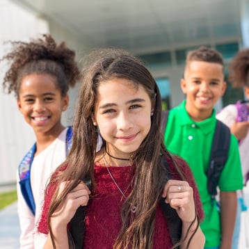 Students standing outside a classroom representing financial literacy.